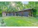 Exterior of a large outbuilding with four bays and a grassy yard at 7901 Bud Henderson Rd, Huntersville, NC 28078