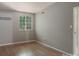 Neutral bedroom with wood flooring, a window, and light gray colored walls at 8019 Walnut Creek Ln, Charlotte, NC 28227