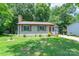 Charming single-story home featuring a brick chimney, neutral siding, and well-maintained front lawn at 8019 Walnut Creek Ln, Charlotte, NC 28227
