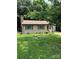 Quaint single-story home with a brick chimney, brown shutters, and a well-manicured lawn at 8019 Walnut Creek Ln, Charlotte, NC 28227