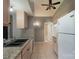 Kitchen featuring light wood cabinets, granite counters, double sinks, and tiled floors at 8019 Walnut Creek Ln, Charlotte, NC 28227