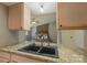 Bright kitchen features granite counters and light wood cabinets at 8019 Walnut Creek Ln, Charlotte, NC 28227