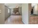 Open-concept living room featuring a brick fireplace, ceiling fan, and hardwood floors at 8019 Walnut Creek Ln, Charlotte, NC 28227