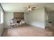 Spacious living room featuring a brick fireplace, ceiling fan, and hardwood floors at 8019 Walnut Creek Ln, Charlotte, NC 28227