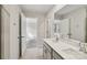 Bright bathroom featuring double sinks, a large mirror, and an open doorway to a carpeted room at 908 Smithcliffs Trl, York, SC 29745