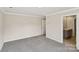 Large bedroom featuring neutral paint, carpet flooring, and an en-suite bathroom at 908 Smithcliffs Trl, York, SC 29745