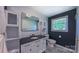 Stylish bathroom features a modern vanity with black countertop, updated fixtures and decorative patterned floor tile at 920 Thomas St, Statesville, NC 28677