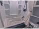 Bathroom featuring white tub, built-in shelves, and black hardware at 920 Thomas St, Statesville, NC 28677
