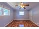 Bright bedroom with two windows, laminate flooring, and a ceiling fan at 920 Thomas St, Statesville, NC 28677