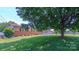 Well-maintained front yard showcasing lush green grass and mature trees for a picturesque setting at 920 Thomas St, Statesville, NC 28677
