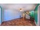 Open living room features wood-look flooring, ceiling fan, and stairs to the next level at 920 Thomas St, Statesville, NC 28677