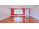 Bright living room features hardwood floors, large window, and modern ceiling fan at 920 Thomas St, Statesville, NC 28677