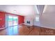 Bright living room with fireplace, slider to outdoor deck, and access to the front door at 920 Thomas St, Statesville, NC 28677