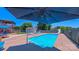 Inviting pool with clear blue water, umbrella, slide, with deck and home in background at 920 Thomas St, Statesville, NC 28677