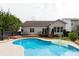 Spacious backyard with a private pool, wooden deck, and lush landscaping creating a serene outdoor retreat at 1003 Grayscroft Dr, Waxhaw, NC 28173
