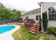 Charming backyard featuring a wooden deck, a pool, and lush greenery for outdoor enjoyment at 1003 Grayscroft Dr, Waxhaw, NC 28173