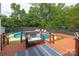 Inviting backyard oasis with a pool, deck, lounge chairs, and a cozy bench, perfect for relaxation and entertaining at 1003 Grayscroft Dr, Waxhaw, NC 28173
