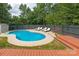 Backyard pool with sun loungers, surrounded by mature trees and a privacy fence at 1003 Grayscroft Dr, Waxhaw, NC 28173