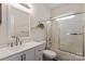 Well-lit bathroom featuring a white vanity, brushed nickel fixtures, and a shower over tub with sliding glass doors at 1003 Grayscroft Dr, Waxhaw, NC 28173