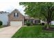 Charming brick home featuring a well-maintained lawn, mature trees, and attached two-car garage at 1003 Grayscroft Dr, Waxhaw, NC 28173