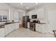 Well-equipped kitchen featuring white cabinets, stainless steel appliances, and ample counter space at 1003 Grayscroft Dr, Waxhaw, NC 28173