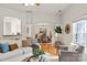 Open-concept living room with hardwood floors, seamlessly connecting to the dining area for easy entertaining at 1003 Grayscroft Dr, Waxhaw, NC 28173