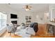 Spacious living room featuring hardwood floors, a fireplace, and comfortable seating arrangements at 1003 Grayscroft Dr, Waxhaw, NC 28173