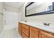 Bathroom with double sink vanity, white toilet, and shower with white tile at 10032 Pergola View Ct, Charlotte, NC 28213