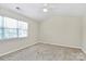 Bedroom with neutral carpet, ceiling fan, and large window at 10032 Pergola View Ct, Charlotte, NC 28213