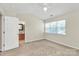 Bedroom with neutral carpet, ceiling fan, and large window; bathroom to the side at 10032 Pergola View Ct, Charlotte, NC 28213