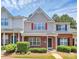 Charming two-story townhome with red brick, red shutters, and manicured landscaping at 10032 Pergola View Ct, Charlotte, NC 28213