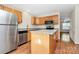 Functional kitchen with stainless steel appliances, an island, and light wood cabinetry at 10032 Pergola View Ct, Charlotte, NC 28213