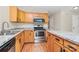Well-equipped kitchen with stainless steel appliances, light wood cabinets and granite countertops at 10032 Pergola View Ct, Charlotte, NC 28213
