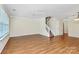 Spacious living room with hardwood floors, a ceiling fan, and ample natural light at 10032 Pergola View Ct, Charlotte, NC 28213