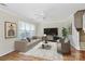 Comfortable living room with stylish furnishings, a ceiling fan, and bright, natural lighting at 10032 Pergola View Ct, Charlotte, NC 28213