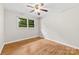 Bright bedroom with hardwood floors, a ceiling fan, and a large window at 1156 Westover Cir, Rock Hill, SC 29732