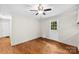 This bright bedroom features hardwood floors, a ceiling fan, and a door to the backyard at 1156 Westover Cir, Rock Hill, SC 29732