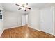 A bedroom with hardwood floors, a ceiling fan, white walls, and two white doors, capturing a bright aesthetic at 1156 Westover Cir, Rock Hill, SC 29732