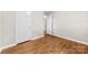 A bedroom with hardwood floors, white walls, and two white doors, capturing a bright and minimalist aesthetic at 1156 Westover Cir, Rock Hill, SC 29732