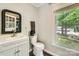 Charming powder room with a modern vanity, toilet, and window view at 1175 18Th Ne Ave, Hickory, NC 28601