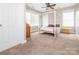 Cozy bedroom with a four-poster bed, ceiling fan, and natural light from window at 13604 Morehouse St, Huntersville, NC 28078