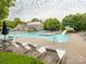 Community pool with plenty of seating, umbrellas, slide, and an adjacent clubhouse for residents at 13604 Morehouse St, Huntersville, NC 28078