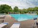 Large community pool provides ample seating and a pergola offering shade for residents' enjoyment at 13604 Morehouse St, Huntersville, NC 28078