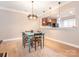 Open dining area with laminate floors and a view into the adjacent kitchen at 13604 Morehouse St, Huntersville, NC 28078