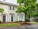 Charming townhome featuring light green siding, bay window, and a black front door, nestled beneath the shade of a mature tree at 13604 Morehouse St, Huntersville, NC 28078