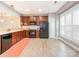 Bright kitchen boasts wood cabinets, black appliances, and light-colored flooring, complemented by a subway tile backsplash and natural light at 13604 Morehouse St, Huntersville, NC 28078