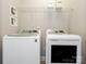 Modern laundry room with new appliances and overhead shelving for efficient storage and organization at 13604 Morehouse St, Huntersville, NC 28078