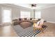 Comfortable living room design featuring stylish furniture and a door leading to the outside at 13604 Morehouse St, Huntersville, NC 28078