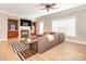 Bright living room featuring a ceiling fan, fireplace, and comfortable seating area at 13604 Morehouse St, Huntersville, NC 28078