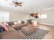 Open-concept living room featuring a ceiling fan and seamless flow to the dining and kitchen areas at 13604 Morehouse St, Huntersville, NC 28078